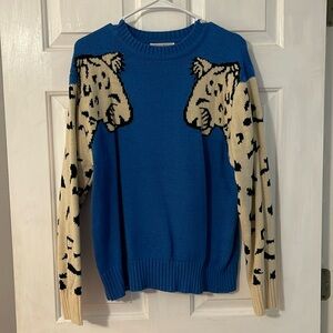 Gently used sweater with fun, leopard print sleeves